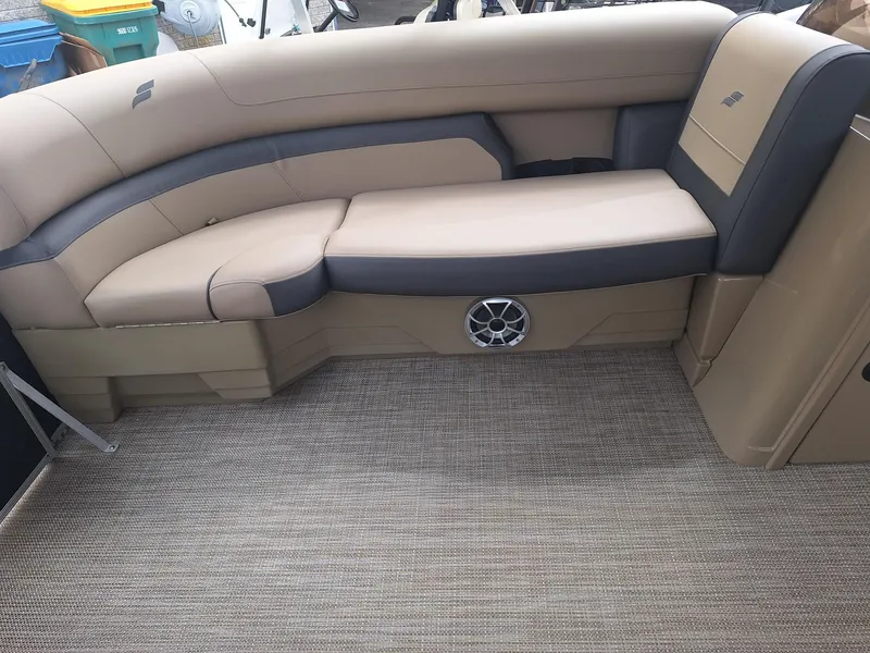 Slide: The Image of 2024 Starcraft EX 22 Weekender boat interior with beige and gray seating. - 18