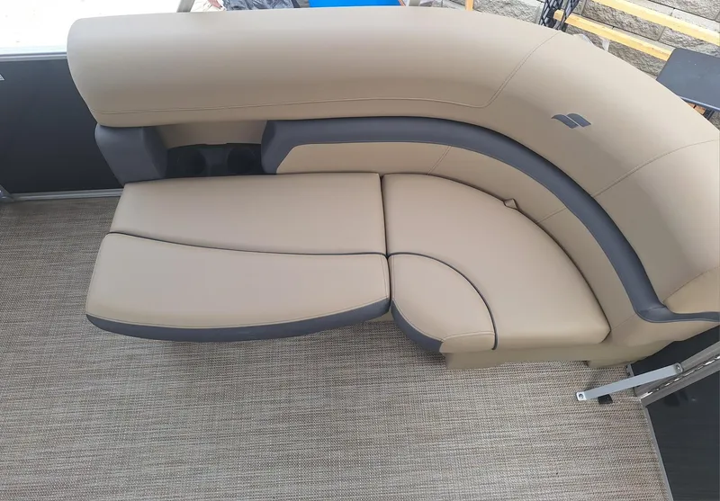 Slide: The Image of 2024 Starcraft EX 22 Weekender boat interior with beige cushioned seating. - 19