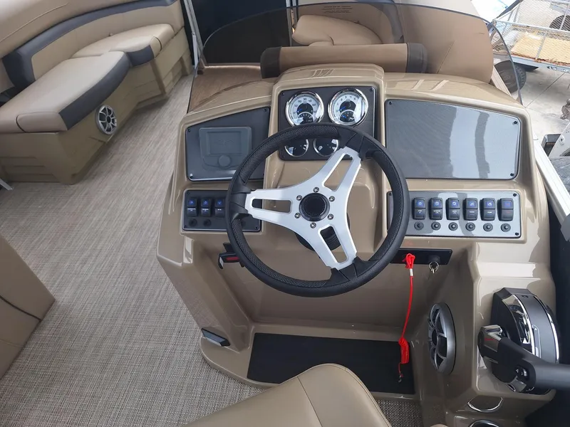 Slide: The Image of 2024 Starcraft EX 22 Weekender boat interior with steering wheel and control panel. - 21