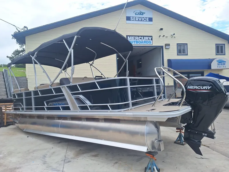 Slide: The Image of 2024 Starcraft EX 22 Weekender pontoon boat with Mercury outboard at service center. - 4