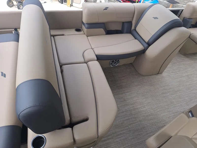 Slide: The Image of 2024 Starcraft EX 22 Weekender boat interior with beige and gray seating. - 8