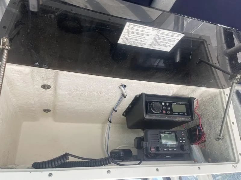 Slide: The Image of Electronics compartment of 2000 Boston Whaler 260 Outrage with radio equipment. - 10