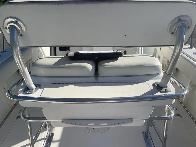 Slide: The Image of Boston Whaler 260 Outrage 2000 boat seating with stainless steel frame and white cushions. - 16