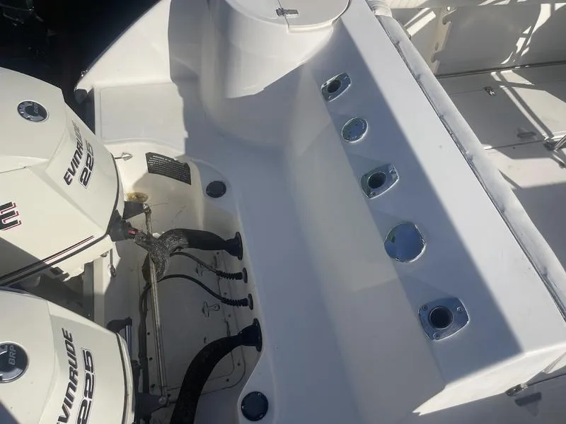 Slide: The Image of Boston Whaler 260 Outrage 2000 boat deck with Evinrude engines and rod holders. - 17