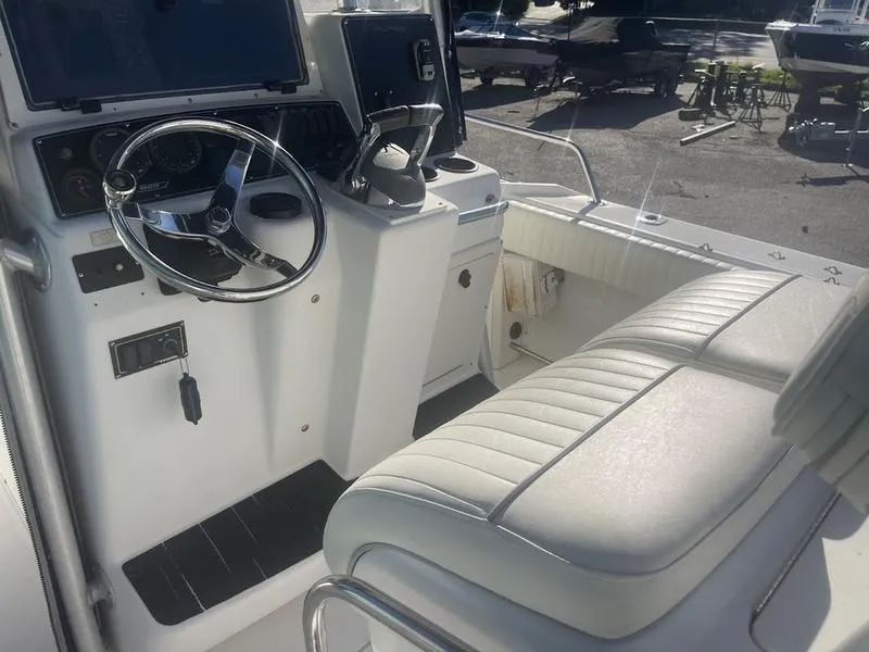 Slide: The Image of Boston Whaler 260 Outrage 2000 boat interior with steering wheel and seating. - 18
