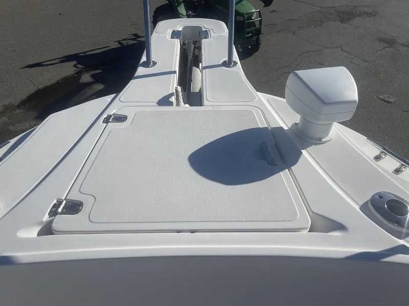 Slide: The Image of 2000 Boston Whaler 260 Outrage boat deck, featuring storage compartments and navigation equipment. - 6
