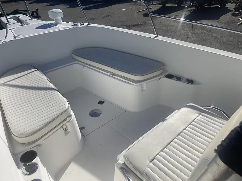 Slide: The Image of 2000 Boston Whaler 260 Outrage boat interior with white cushioned seating. - 7
