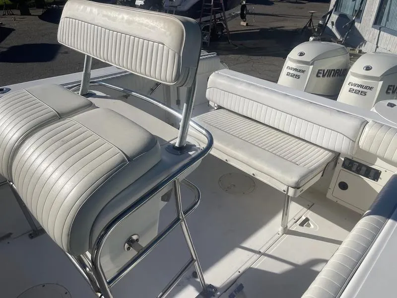 Slide: The Image of Boston Whaler 260 Outrage 2000 boat interior with white seating and Evinrude engines. - 8