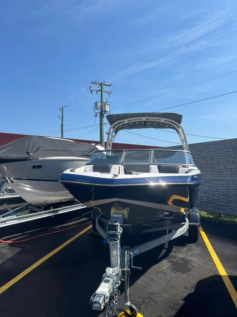 Slide: The Image of 2021 Yamaha Boats 195S on trailer in parking lot. - 2