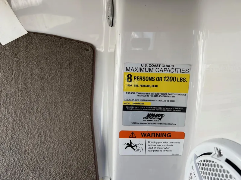 Slide: The Image of 2008 Four Winns H200 boat capacity label, 8 persons or 1200 lbs, safety warning. - 12