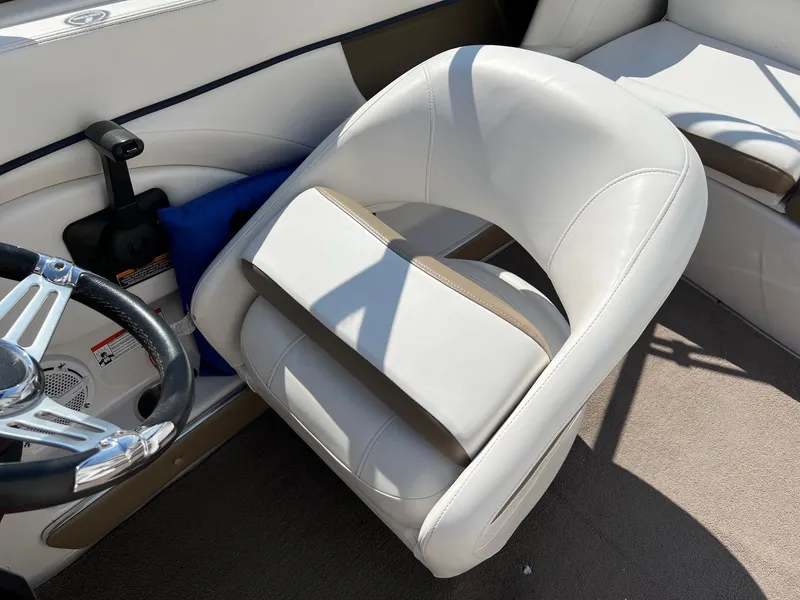 Slide: The Image of 2008 Four Winns H200 boat interior with white captain's chair and steering wheel. - 13