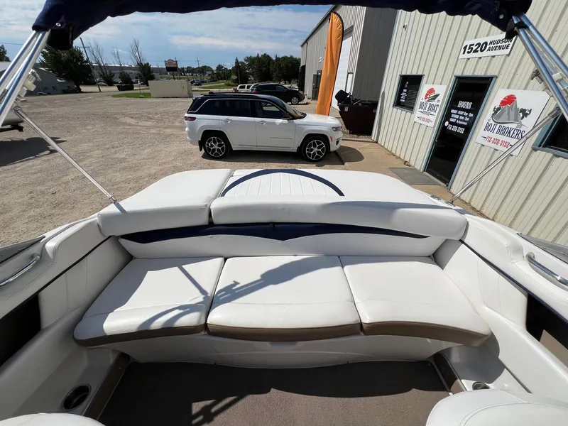 Slide: The Image of 2008 Four Winns H200 boat interior with white seating at dealership. - 17