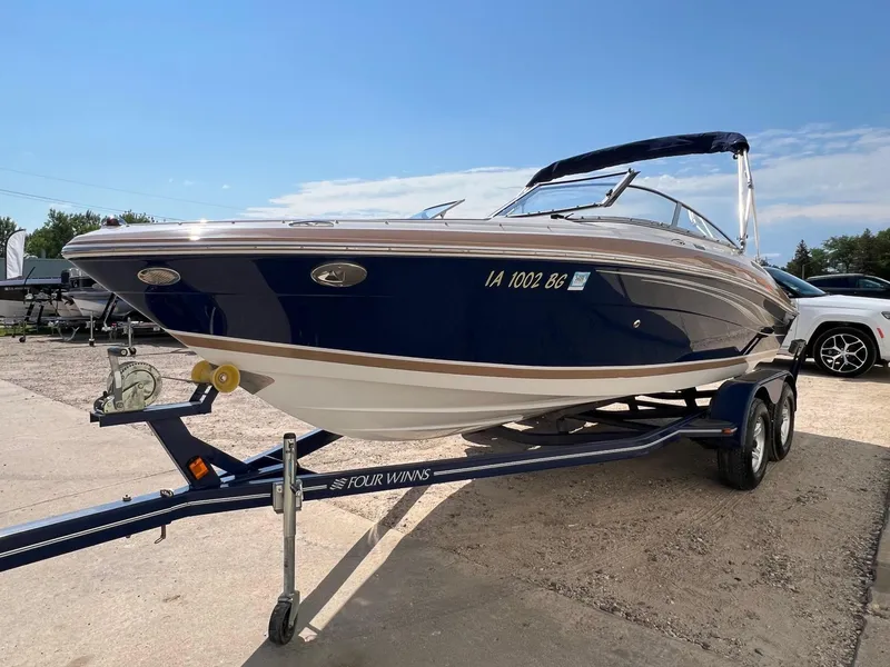 Slide: The Image of 2008 Four Winns H200 boat on trailer, blue and white, sunny day. - 2