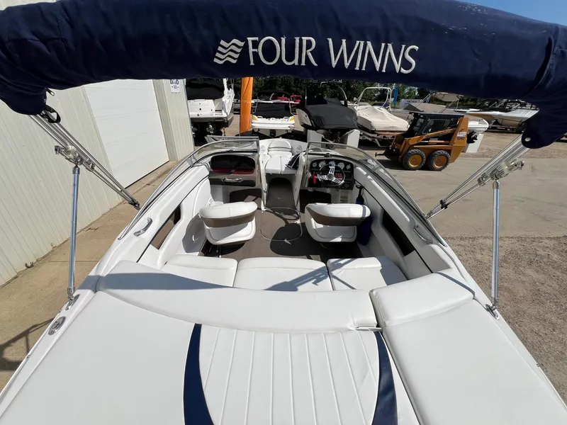 Slide: The Image of 2008 Four Winns H200 boat interior with white seating and blue canopy. - 5