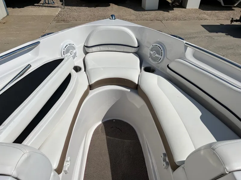 Slide: The Image of 2008 Four Winns H200 boat interior with white cushioned seating and built-in speakers. - 7