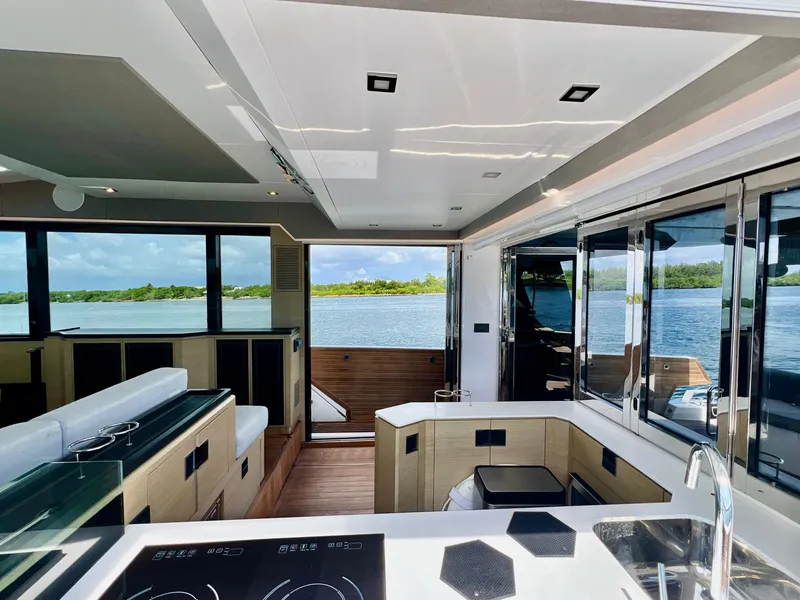 Slide: The Image of Interior of 2022 OKEAN Flybridge 50 yacht with modern kitchen and scenic water view. - 11