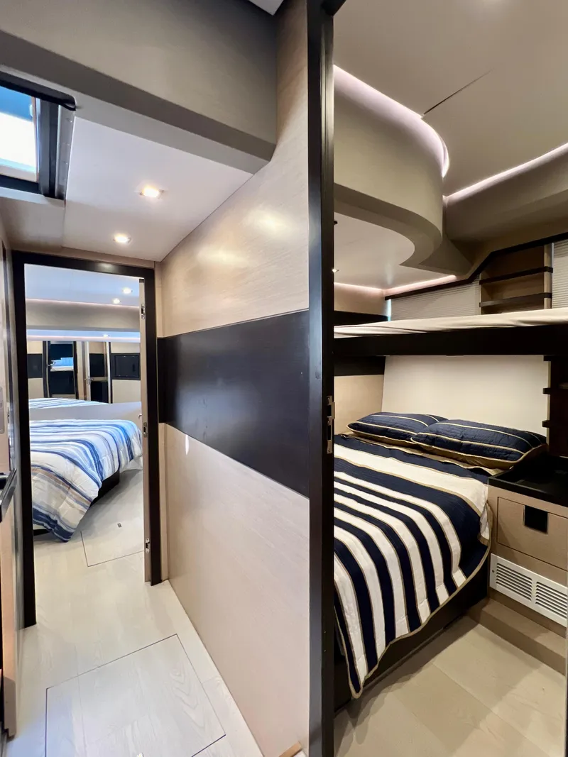 Slide: The Image of 2022 OKEAN Flybridge 50 yacht interior with modern bedroom and bunk beds. - 30