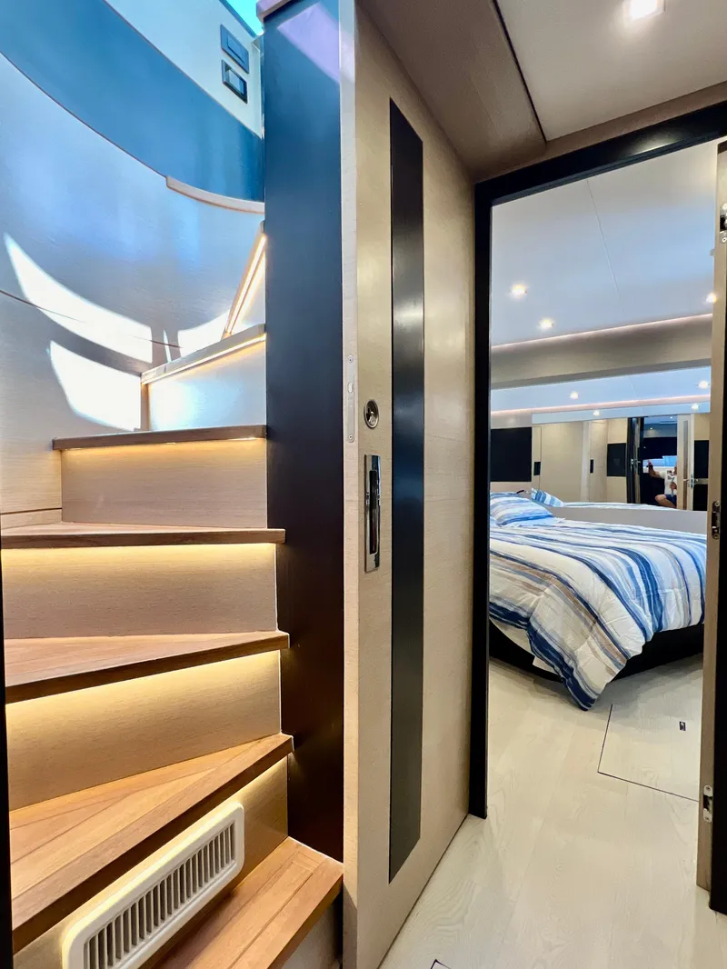 Slide: The Image of Modern interior of 2022 OKEAN Flybridge 50 yacht with wooden stairs and cozy bedroom. - 32