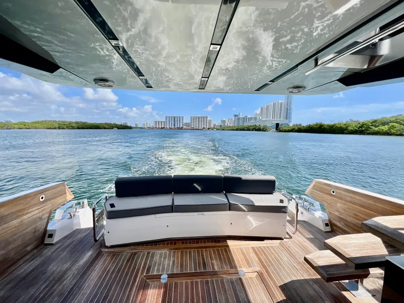 Slide: The Image of 2022 OKEAN Flybridge 50 yacht cruising with city skyline in the background. - 35