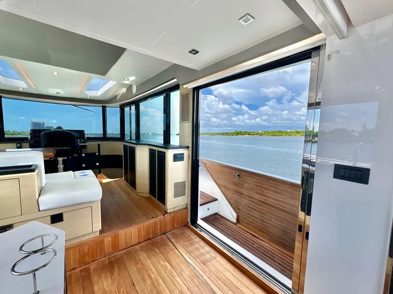 Slide: The Image of Interior of 2022 OKEAN Flybridge 50 yacht with open sliding door and scenic water view. - 36