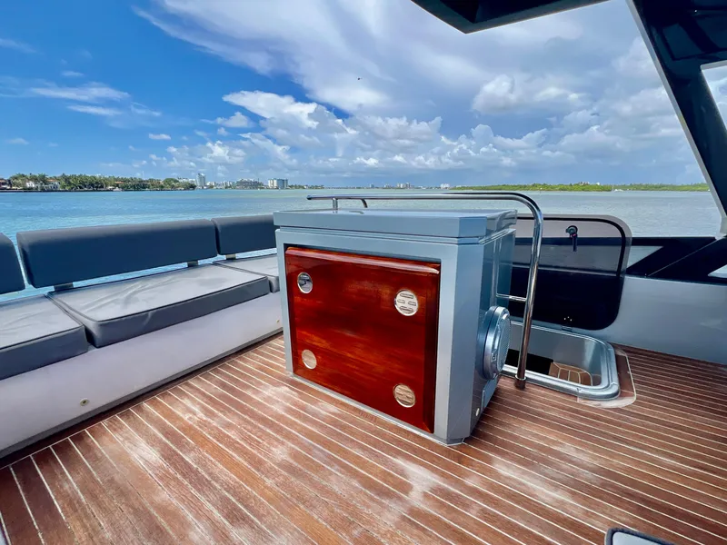 Slide: The Image of 2022 OKEAN Flybridge 50 yacht deck with seating and storage, overlooking serene waters. - 40