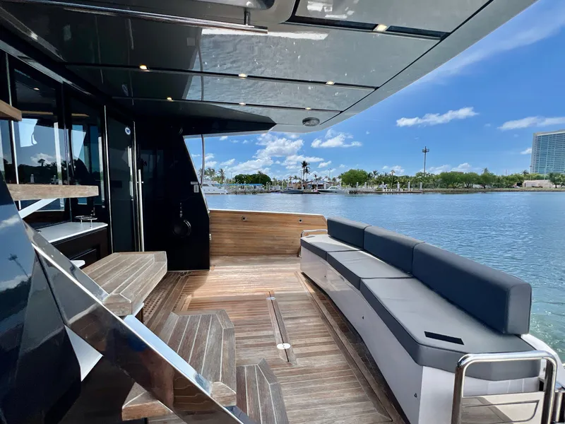 Slide: The Image of Luxury 2022 OKEAN Flybridge 50 yacht with spacious deck and waterfront view. - 43