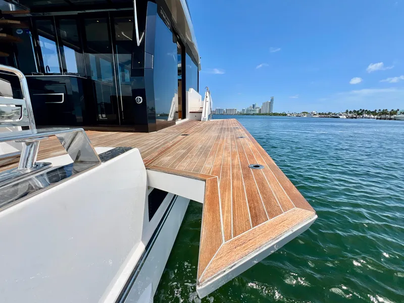 Slide: The Image of 2022 OKEAN Flybridge 50 yacht with extended wooden deck on water. - 45