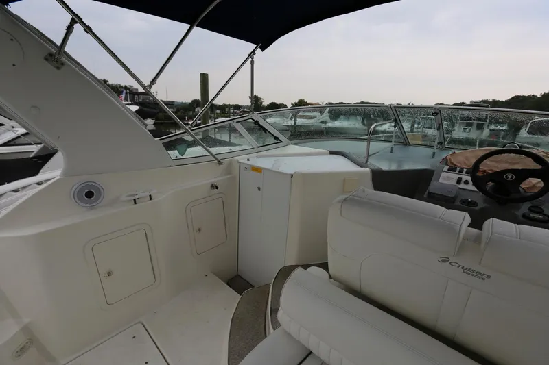 Slide: The Image of 2005 Cruisers Yachts 280 CXi Express boat interior with seating and helm. - 12