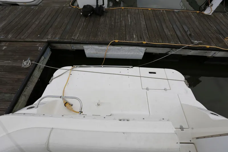 Slide: The Image of 2005 Cruisers Yachts 280 CXi Express docked at a wooden pier. - 13