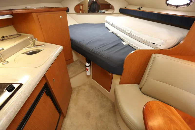 Slide: The Image of Interior cabin of a 2005 Cruisers Yachts 280 CXi Express with bed, kitchenette, and seating. - 14