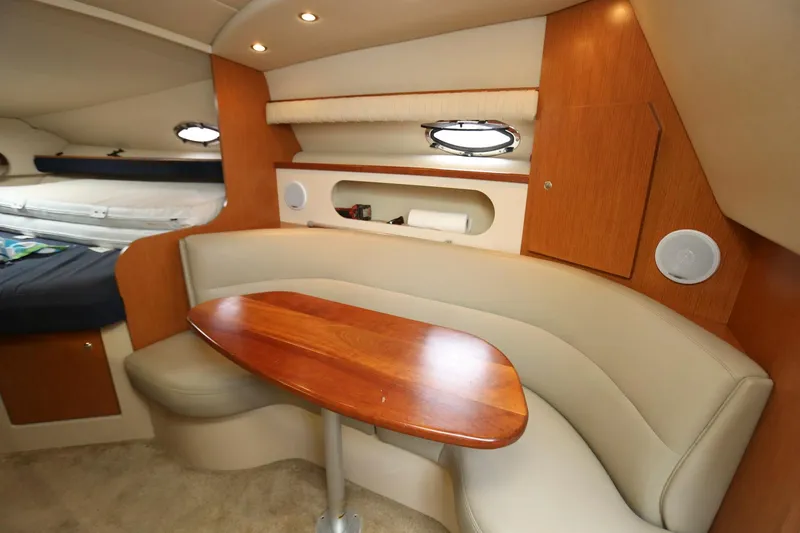 Slide: The Image of 2005 Cruisers Yachts 280 CXi Express cabin interior with dining area and wooden table. - 15