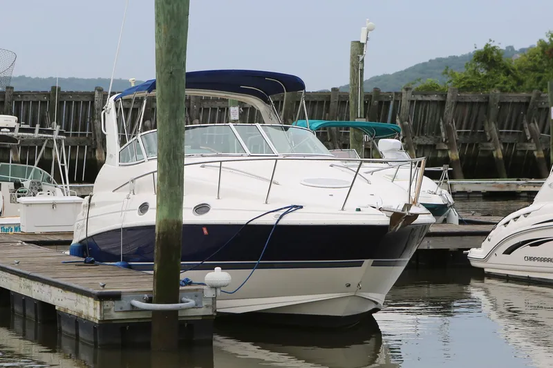 Slide: The Image of 2005 Cruisers Yachts 280 CXi Express docked at a marina. - 2