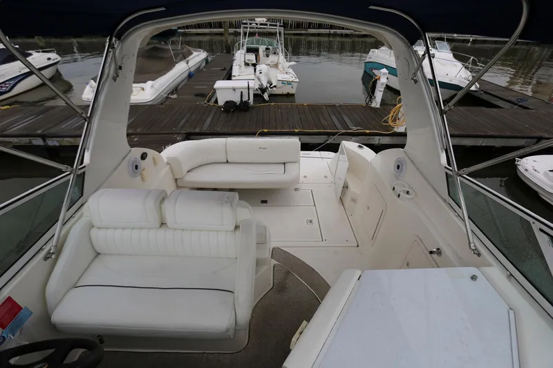 Slide: The Image of 2005 Cruisers Yachts 280 CXi Express interior with white seating at marina. - 6