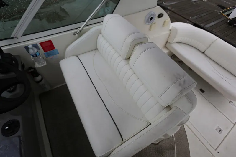 Slide: The Image of 2005 Cruisers Yachts 280 CXi Express cockpit seating with white upholstery. - 8