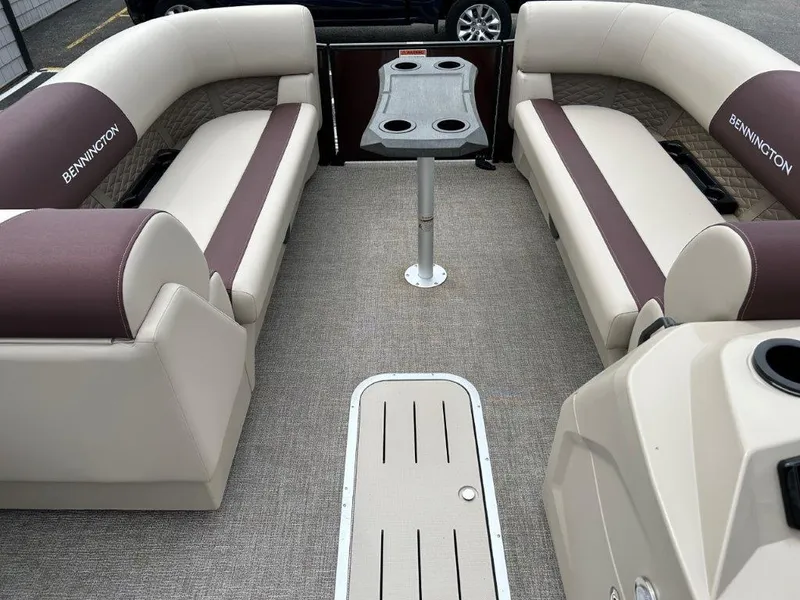 Slide: The Image of 2024 Bennington 22SSR boat interior with beige and brown seating and a central table. - 5
