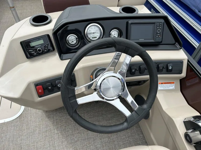 Slide: The Image of 2024 Bennington 22SSR boat dashboard with steering wheel, gauges, and control panel. - 6
