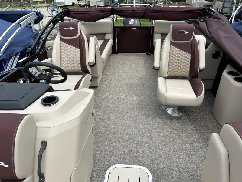 Slide: The Image of 2024 Bennington 22SSR pontoon boat interior with beige and maroon seating. - 8
