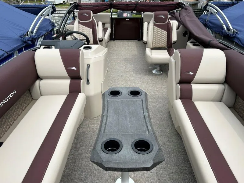 Slide: The Image of 2024 Bennington 22SSR pontoon boat interior with beige and maroon seating. - 9