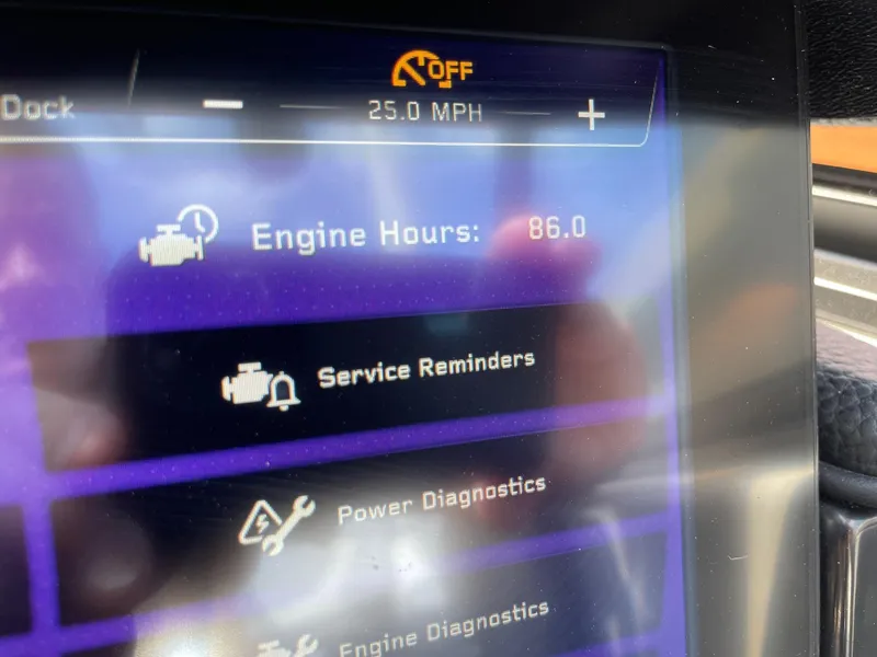 Slide: The Image of Close-up of 2022 Nautique Super Air G23 dashboard showing 86 engine hours. - 12