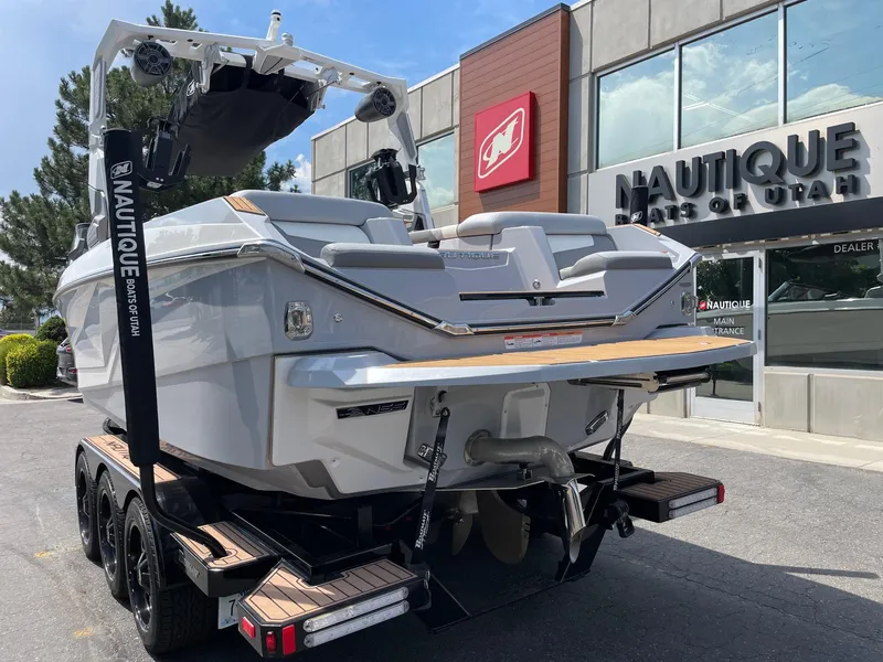 Slide: The Image of 2022 Nautique Super Air G23 boat on trailer outside Nautique dealership. - 3