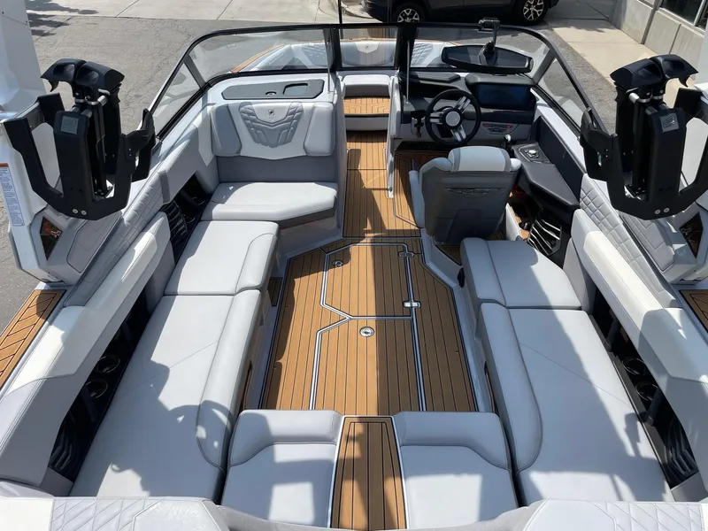 Slide: The Image of 2022 Nautique Super Air G23 boat interior with luxurious seating and modern dashboard. - 5