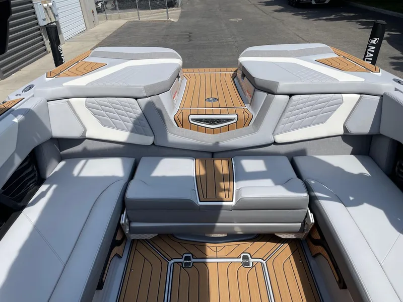 Slide: The Image of 2022 Nautique Super Air G23 boat interior with luxurious seating and teak flooring. - 8