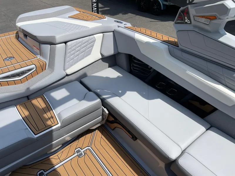 Slide: The Image of 2022 Nautique Super Air G23 boat interior with luxurious seating and teak flooring. - 9
