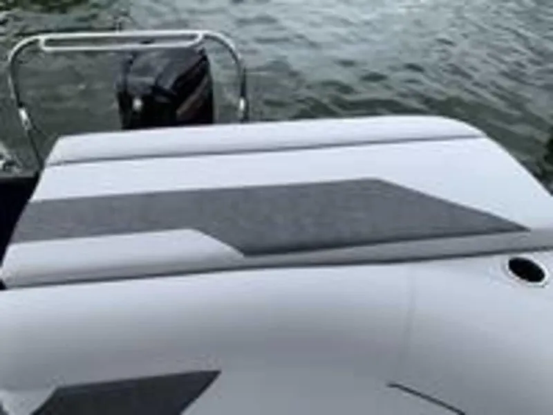 Slide: The Image of 2021 Crest Classic LX 240 L boat with cushioned seating and outboard motor on water. - 3