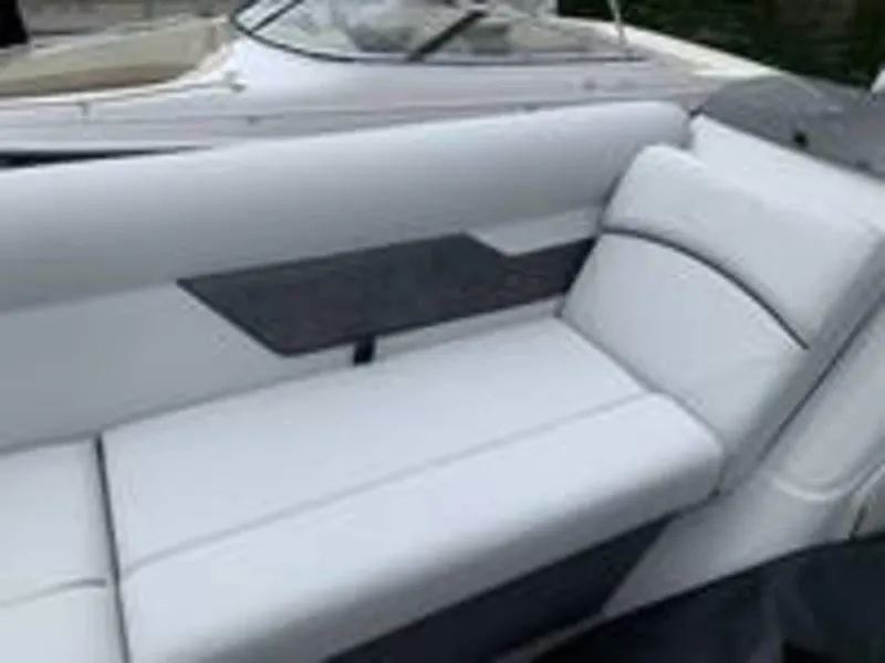 Slide: The Image of 2021 Crest Classic LX 240 L boat interior with white cushioned seating. - 5