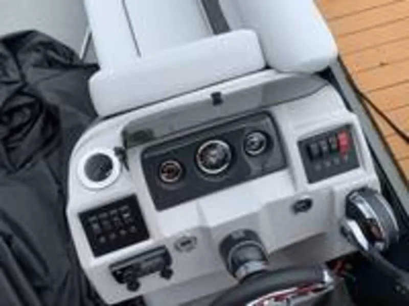 Slide: The Image of 2021 Crest Classic LX 240 L boat dashboard with controls and gauges. - 6