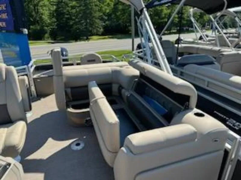 Slide: The Image of 2024 Sun Tracker SF 20 DLX pontoon boat interior with beige seating and open storage. - 11
