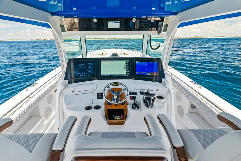 Slide: The Image of 2022 HCB Suenos boat cockpit with advanced navigation systems on open water. - 21