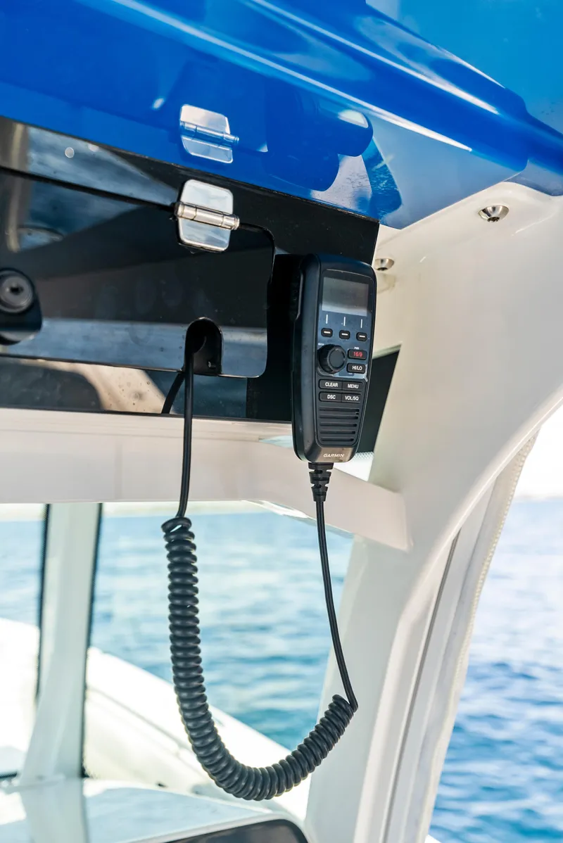 Slide: The Image of 2022 HCB Suenos boat communication device under blue canopy, ocean in background. - 26