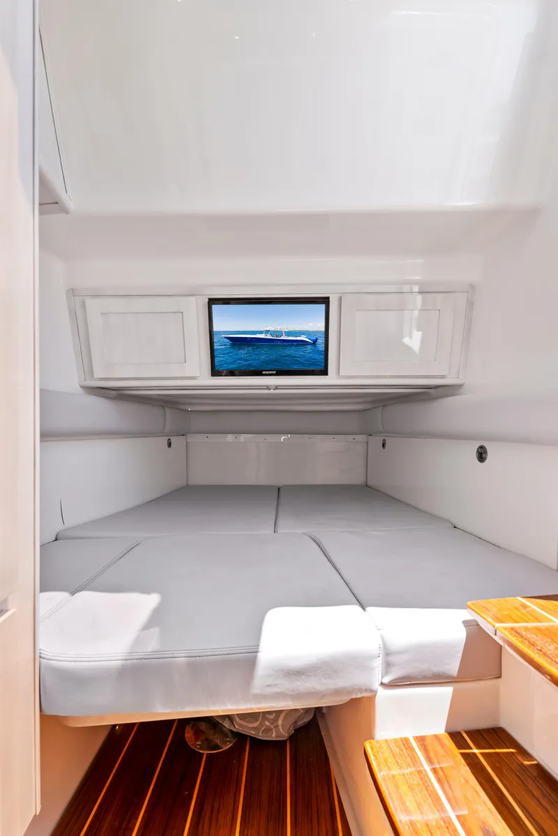 Slide: The Image of 2022 HCB Suenos cabin interior with bed, TV, and wooden steps. - 38